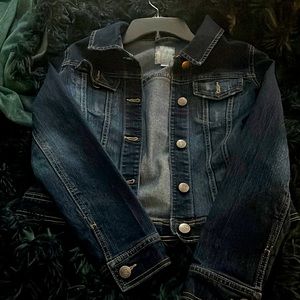 A dark blue jean jacket large in children size